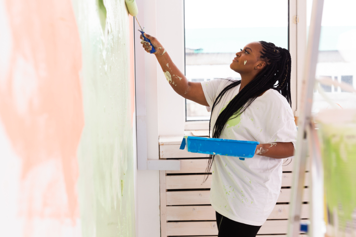 afro-woman-painting-the-walls-of-new-home-renovat-2021-12-09-07-26-57-utc (1) - JN Bank